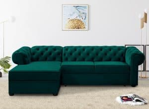 A dark green corner sofa with tufted design set in a modern living room, complemented by decorative elements.